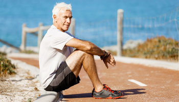 Man in sports wear sitting at the beach elder old gentleman man